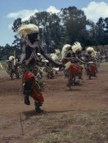 All male traditionally adorned Tutsi intore dancers characterised by coordinated drilling dances reflecting the Tutsi warrior tradition Watutsi  Watutsi