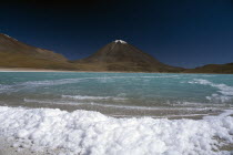 Salar de Uyuni  Laguna Verde.  Salt crusted shore and jade coloured water. Colored  Colored