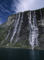 Seven Sisters mountain cliff with cascading waterfall.