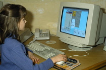 Young girl using educational software on a home computer.