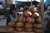 Girls selling decorated bread for Day of the Dead.