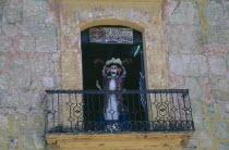 Skeleton figure on shop window balcony for Day of the Dead.