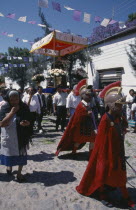 Templo de San Juan de Dios.  Easter procession with people dressed as Roman centurions and others carrying figure of Christ on flower strewn platform.