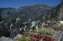 Curral das Freiras. Photographs of the dead with flowers outside the Church of Senhora do Livramento which are removed after five years