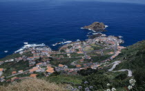 Elevated view from the north coast road over Porto do Moniz rooftops and coastline