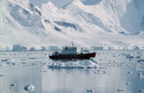 British Ice Patrol ship HMS Endurance on water with snow covered mountains behind