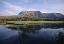 Landscape with Sofa Mountain reflected in lake.