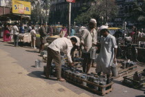 Lunch time tiffin wallahs distributing tiffin boxes to city workers. Mumbai