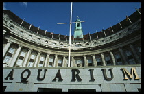 Looking up at curved Aquarium exterior and name sign on the County Hall building