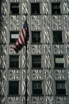 American flag flying in front of building with aluminium facade