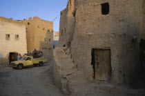 Pick-up truck loaded with people and goods in street below Shali Fortresspick up