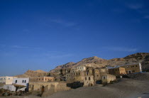 General view of the village buildings with hills behind Gurna