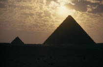 The Pyramids silhouetted at sunset.