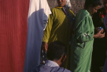 Women at souk in bright coloured clothing Market