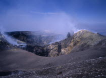 Sulphur coated edge of the smoking summit crater      volcano