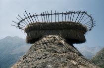 Kogi religious centre of Mamarongo.  View of  nuhue   / temple roof with potsherds in the rack at apex. In background high peaks of the Sierra NevadaIndigenous Tribes  American Center Colombian Relig...