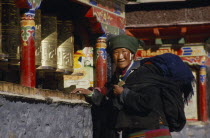 A pilgrim turning prayer wheels outside the monastery.