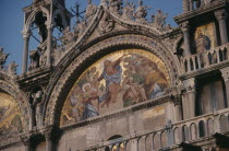 St Marks Square.  Detail of mosaic and carvings on exterior facade of Basilica di San Marco.St Marks Basilica