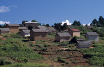 Road to Ambalavao. Thatched huts set into hillside