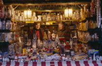 Women vendors in decorated stall in Christmas market selling glassware  candles and Christmas decorations. Bavaria