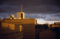 City view of roof tops at sunset with a stormy sky.