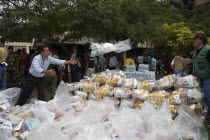 Distribution of relief food packages after heavy rains cut off access to the region