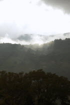 Late afternoon scene with sun breaking through clouds  hills close to Merida