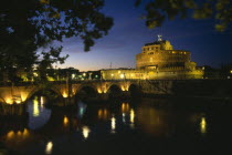 Ponte Sant  Angelo and Castel Sant  Angelo at night with lights reflected in the water.  Citadel built as a mausoleum for the Emperor Hadrian in AD 139