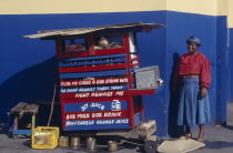 Street vendor with religious text painted on stall.