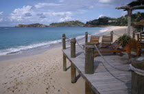 View along the beach from a wooden hotel beach terrace