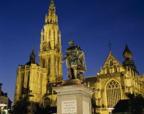 Cathedral of Notre Dame with statue of the seventeenth century artist Peter Paul Rubens in the foreground illuminated at night.Cathedral of Our Lady