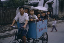 Cycle powered baby carriage full of young children.