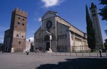 Italy, Veneto, Verona, Basilica di San Zeno Maggiore exterior between bell tower on the right and another crenellated tower on the left .