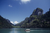 Pulau Dayang Bunting island with a traditional covered boat used for transport between the islands