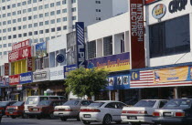 Kuah old town electrical goods shops with cars parked in front