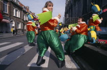 Woluwe St. Lambert  Spring Festival.  Group of people in green and orange Mardi Gras costumes.