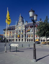 Town Hall and Main Square  Grote Markt  with a lamppost and flag in the foreground.