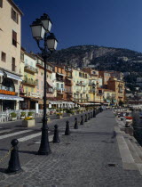 Quayside road lined with restaurants.