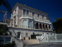 Villa Ephrussi de Rothschild with pink walls and white balconies.