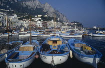 Marina Grande. Moored boats on water with waterside buildings overlooked by mountains