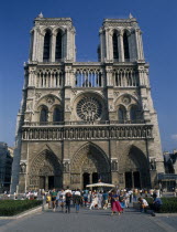 Cathdrale de Notre Dame.  Gothic exterior with twin towers and rose window  crowds of visitors outside entrance.Cathedral