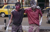 Two young men covered in coloured paint during Holi celebrations.Colored Kolkata