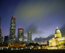 Illuminated skyline of Raffles Place at dusk from Padang.