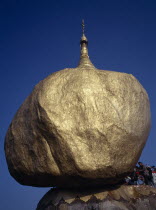 Worshippers at the Golden Rock Pagoda  historical Buddhist pilgrimage siteBago Burma Myanmar Pegu