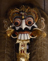 Decorated ornate mask with protruding eyes  teeth and hair