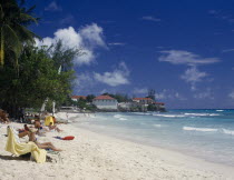 Sunbathers on sandy beach