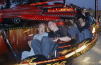 People on a funfair ride at night with movement blur