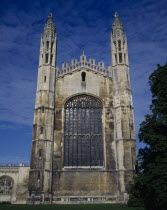 Kings College chapel.  Medieval exterior with stained glass window and two octagonal turrets.