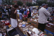 Flea Market. Place du Jeu de Balle  the Marolles. People rummaging through boxes at street market selling second hand goods and bric-a-brac.