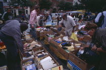 Flea Market. Place du Jeu de Balle  the Marolles. People rummaging through boxes at street market selling second hand goods and bric-a-brac.